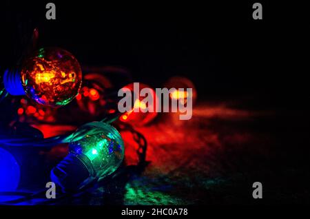 Colored globe lights lay on a table, Dec. 27, 2017, in Coden, Alabama. Globe-style string lights can be used inside or outdoors for a festive touch. Stock Photo