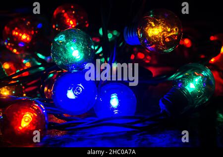 Colored globe lights lay on a table, Dec. 27, 2017, in Coden, Alabama. Globe-style string lights can be used inside or outdoors for a festive touch. Stock Photo