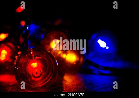 Colored globe lights lay on a table, Dec. 27, 2017, in Coden, Alabama. Globe-style string lights can be used inside or outdoors for a festive touch. Stock Photo