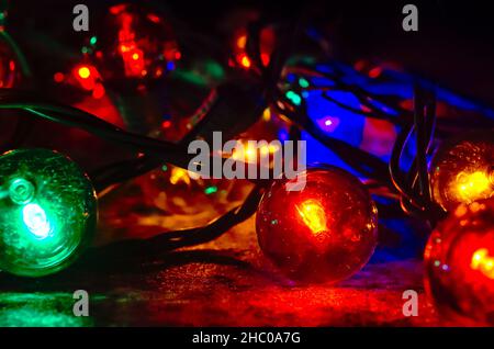 Colored globe lights lay on a table, Dec. 27, 2017, in Coden, Alabama. Globe-style string lights can be used inside or outdoors for a festive touch. Stock Photo