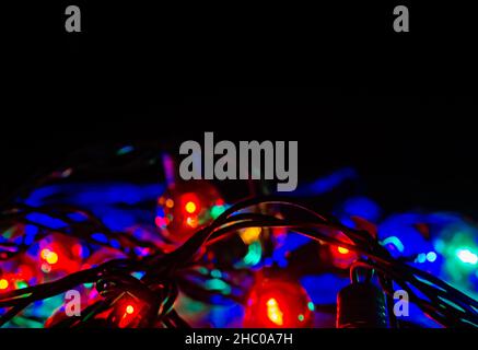 Colored globe lights lay on a table, Dec. 27, 2017, in Coden, Alabama. Globe-style string lights can be used inside or outdoors for a festive touch. Stock Photo