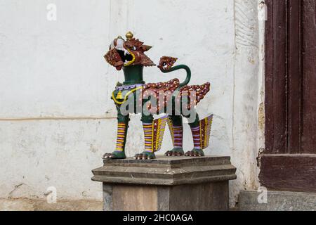 A statue of a guardian lion in the Nasal Chowk of the royal palace of Hanuman Dhoka Durbar Square, Kathmandu, Nepal. Stock Photo