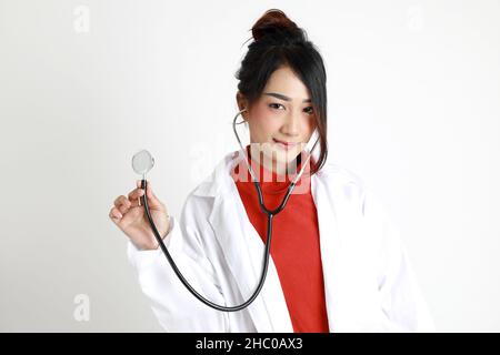 The Asian womna standing on the white background. Stock Photo
