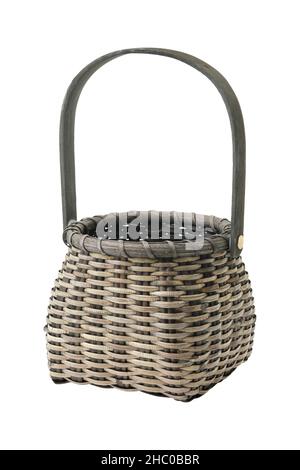 Dark wicker vintage rustic basket, isolated on white. Stock Photo