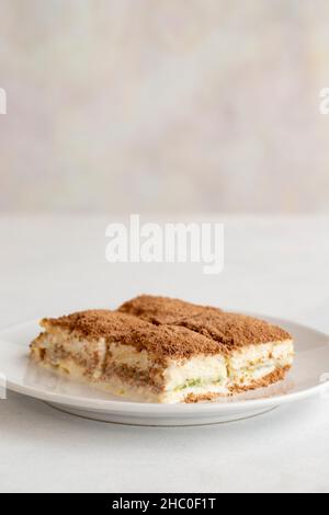 Cold baklava on a white background. Turkish sweet dessert concept. plate of sliced forest fruit cake. Plate of cold milk baklava. Mediterranean bakery Stock Photo