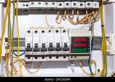 Electrical panel with switches and wires. Conducting electricity to the house. Russia, Anapa - 11.07.2020. Stock Photo