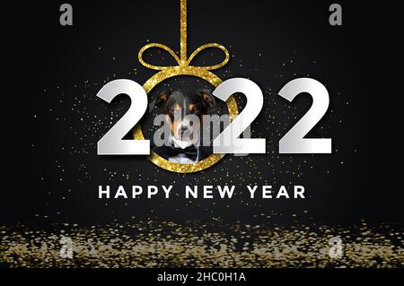 happy new year 2022 with a Dog, black background. Stock Photo