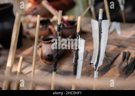 Wooden archery arrows with fletching at medieval outdoor festival - close up Stock Photo