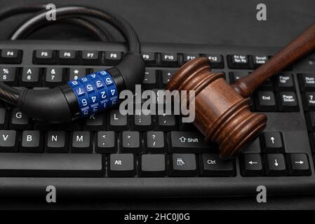 Gavel with combination lock on computer keyboard. Data Protection Concept Stock Photo