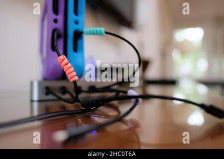 Amazon Fire tablet charging station with two tablets encased in kid proof case with cables connecting to the base for charge. Stock Photo