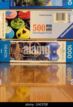 Boxes of assorted jigsaw puzzles by Ravensburger and CEACO puzzle companies; 500, 750, and 1000 pieces. Stock Photo
