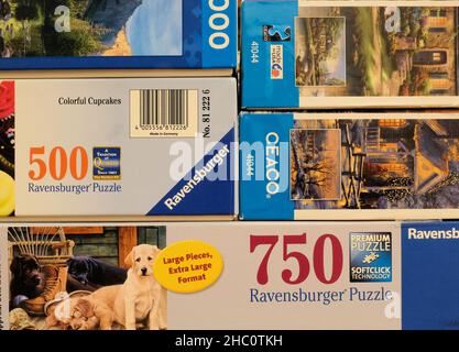 Boxes of assorted jigsaw puzzles by Ravensburger and CEACO puzzle companies; 500, 750, and 1000 pieces. Stock Photo