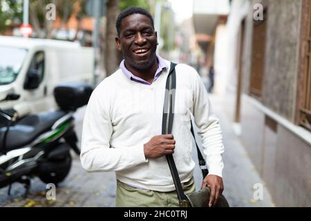 African american adult man walking to work along street Stock Photo