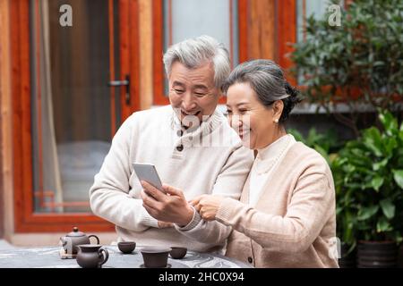 Old couple using a smartphone Stock Photo