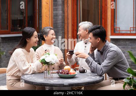 Happy families drinking tea and chatting in the courtyard Stock Photo