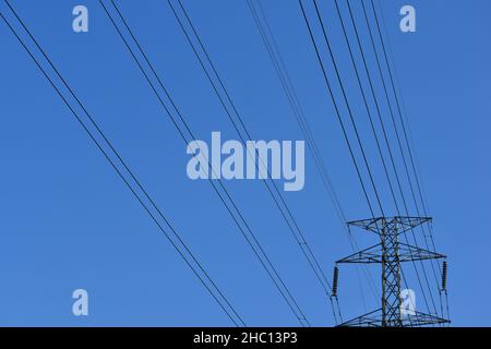 High voltage power lines with clear blue sky Stock Photo