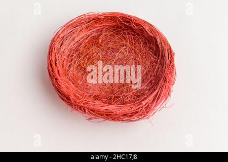 Empty red colored decorative rustic basket for Easter eggs or other decorations isolated on a white table Stock Photo