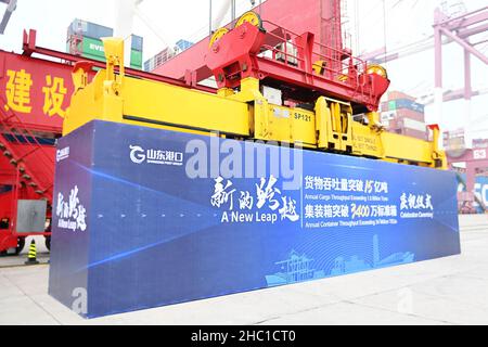QINGDAO, CHINA - DECEMBER 23, 2021 - The 34 millionth teU of Shandong Port Group waits to be hoisted at the Qingdao Port Foreign trade Container Termi Stock Photo