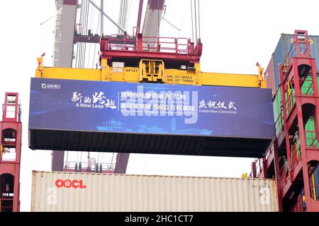 QINGDAO, CHINA - DECEMBER 23, 2021 - The 34 millionth teU of Shandong Port Group is lifted and loaded at the Qingdao Port Foreign trade Container Term Stock Photo