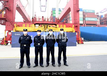 QINGDAO, CHINA - DECEMBER 23, 2021 - Police officers from the Huangdao Border Control Station and Qingdao Port Public Security bureau jointly enforce Stock Photo