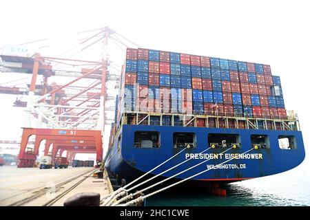 QINGDAO, CHINA - DECEMBER 23, 2021 - The USS Dwight D. Eisenhower is loaded and unloaded containers at the Foreign trade container terminal at Qingdao Stock Photo