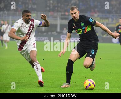 Milan, Italy. 22nd Dec, 2021. FC Inter's Edin Dzeko (R) vies with Bremer during a Serie A football match between FC Inter and Torino in Milan, Italy, on Dec. 22, 2021. Credit: Str/Xinhua/Alamy Live News Stock Photo