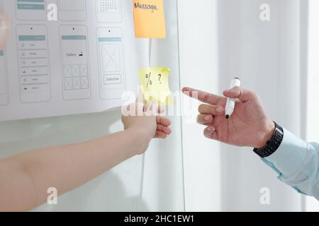 Hands of UX designer and developer working on interface of new mobile application Stock Photo