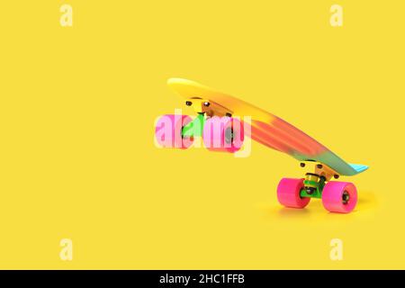 rainbow plastic Penny board skateboard isolated on yellow background Stock Photo