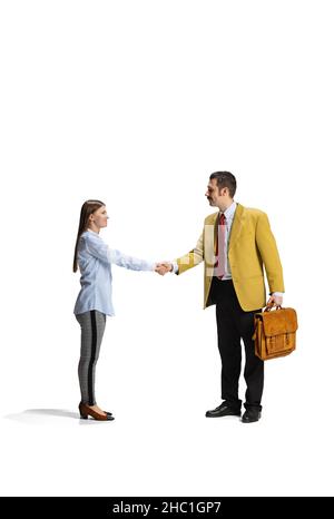 Full-length portrait of two workers shaking hands due to a successful deal isolated over white background Stock Photo