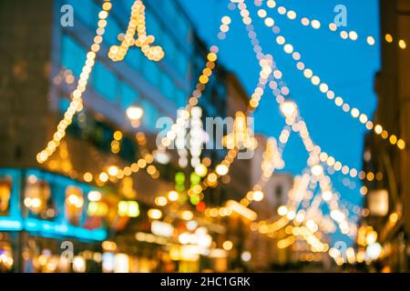 Helsinki, Finland. New Year Boke Lights Xmas Christmas Festive Illumination In Aleksanterinkatu Street. Natural Defocused Blue Bokeh Background Effect Stock Photo