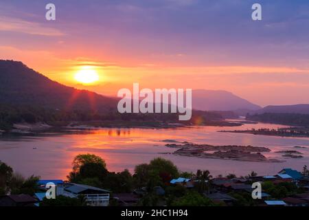 The landscape of the Mekong River at sunrise, fishermen fishing on traditional wooden boats, Khong Chiam district on the riverbank. Thailand-Laos border. Stock Photo