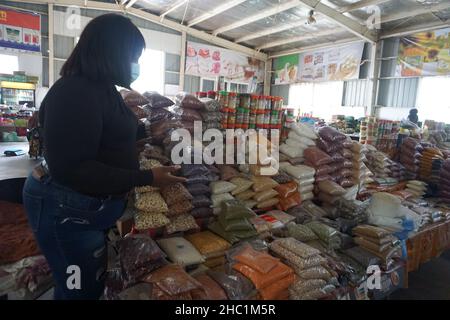 (211220) -- LUSAKA, Dec. 20, 2021 (Xinhua) -- Maria Mukela, a food trader, shows dry foods at JCS Food Market in Lusaka, Zambia, on Dec. 18, 2021. Access to decent trading spaces is a challenge for many small-scale food traders in Zambia. It is for this reason that Jihai Central Sports (JCS) Company Limited, a Chinese-owned entity operating in Zambia, decided to empower local small-scale food traders in Lusaka with clean and affordable trading spaces. (Photo by Lillian Banda/Xinhua) TO GO WITH Feature: Chinese-run company offering Zambian small-scale food traders clean, secure trading spaces Stock Photo