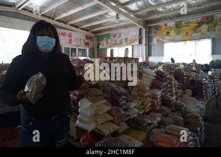 (211220) -- LUSAKA, Dec. 20, 2021 (Xinhua) -- Maria Mukela, a food trader, shows dry foods at JCS Food Market in Lusaka, Zambia, on Dec. 18, 2021. Access to decent trading spaces is a challenge for many small-scale food traders in Zambia. It is for this reason that Jihai Central Sports (JCS) Company Limited, a Chinese-owned entity operating in Zambia, decided to empower local small-scale food traders in Lusaka with clean and affordable trading spaces. (Photo by Lillian Banda/Xinhua) TO GO WITH Feature: Chinese-run company offering Zambian small-scale food traders clean, secure trading spaces Stock Photo