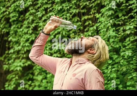 Drink everything to the last drop. healthcare and water balance concept. need to quench thirst. refresh in hot weather. moisturize dry mouth. bearded Stock Photo