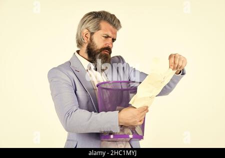Recover document. Destroy evidence. Rummaging in trash. Recover files after deletion. Businessman hold trash can. Man look for lost document in paper Stock Photo