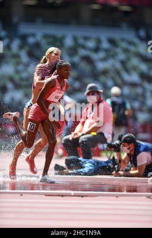 Winfred Mutile Yavi participating in the 3000 Meters Steeplechase at ...