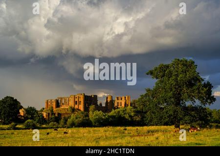 A retreating storm over Kenilworth Castle in Warwickshire, UK, taken shortly before sunset. Stock Photo