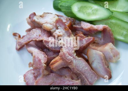 grilled pork neck with slice cucumber on plate dipping spicy sauce Stock Photo