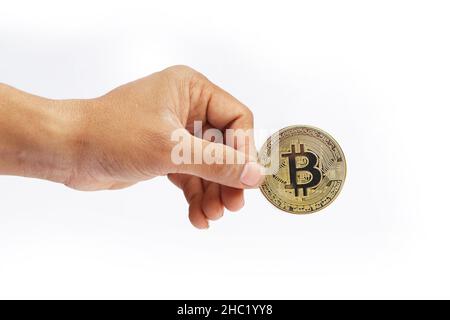 man's hand holding golden Bitcoin isolated on white background Stock Photo
