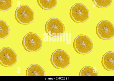 Lemon slices, top view of lemon slices isolated on a yellow background. Citrus pattern concept photo. Stock Photo
