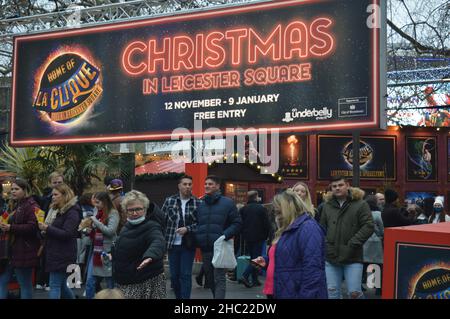 London, UK. December 18, 2021: Shoppers leaving a Christmas market at Leicester Square in London. Stock Photo
