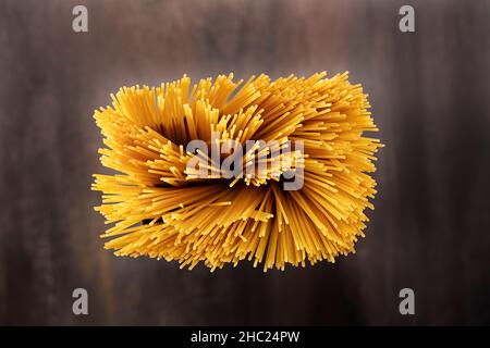 Uncooked spaghetti, top view shooting on rustic wood Stock Photo