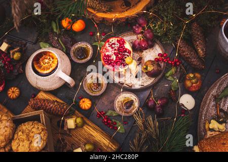 Table setting for a wedding ceremony in an eco style in the forest. Decoration with fresh flowers, candles, moss, garlands. Boho style dining table. V Stock Photo