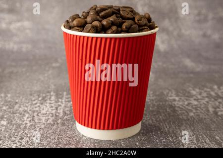 Coffee beans in a red paper cup Stock Photo