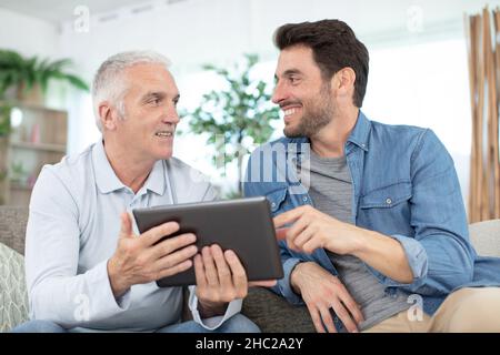 senior father and young son with tablet Stock Photo
