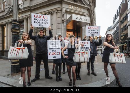 PETA hold up House Of Horrors placards to protest against the use of lizard skin for their handbags outside Gucci Store in London. Stock Photo