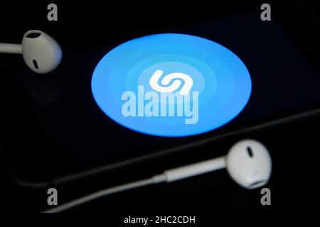 Rheinbach, Germany  4 May 2021,  Close-up of the "Shazam" logo on the screen of a smartphone with headphones Stock Photo