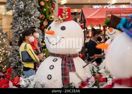 Kuala Lumpur, Malaysia. 23rd Dec, 2021. People wearing face masks walk by the Christmas decorations at a shopping mall in Kuala Lumpur, Malaysia, Dec. 23, 2021. Credit: Chong Voon Chung/Xinhua/Alamy Live News Stock Photo