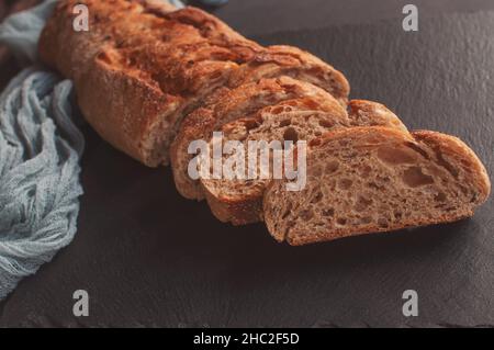 Handmade french bread selection baguette with gray gauze tablecloth on black background Stock Photo