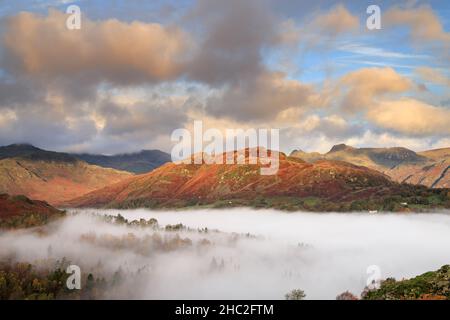 Looking over morning mist towards Lingmoor Fell and the Langdale Pikes. Stock Photo